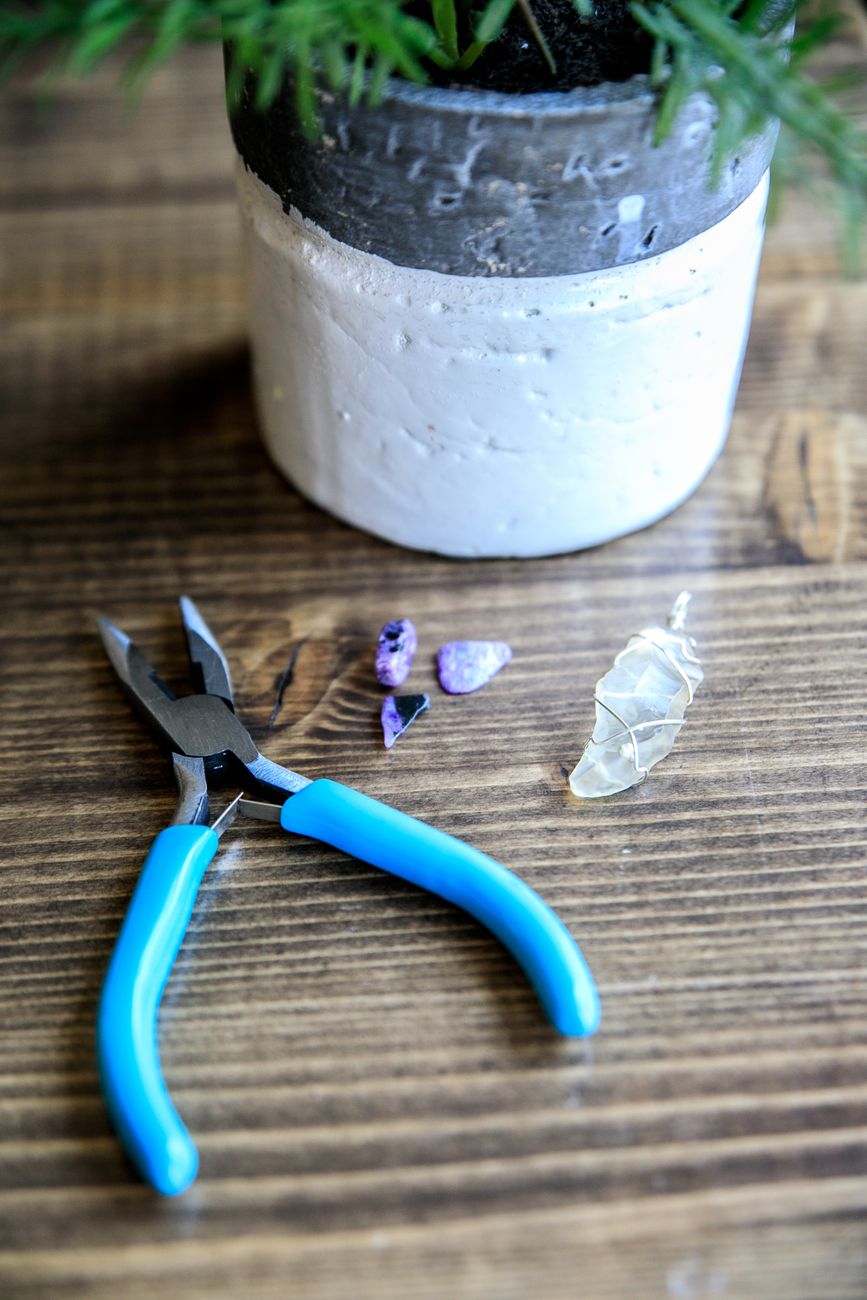 Jewelry-making pliers beside a plant pot